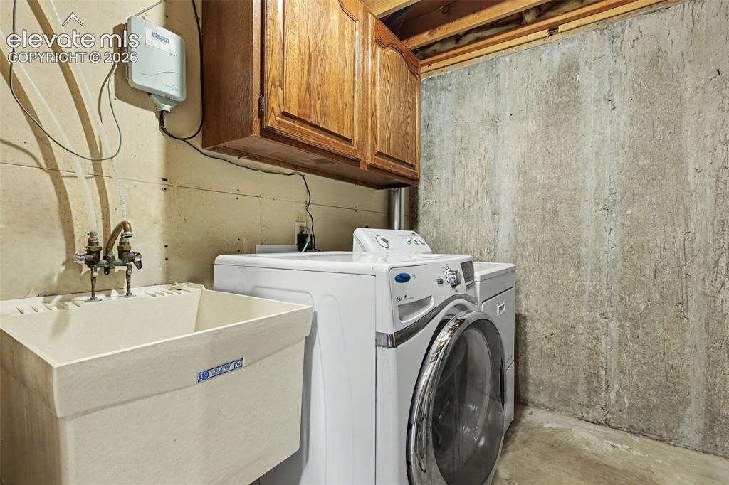 Image 37 of 41: Laundry room w/ sink and storage