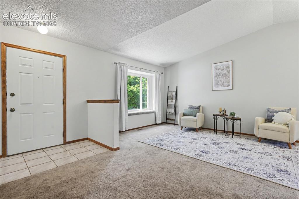 Image 9 of 41: Front door entry on the left; carpeted window seat nook in the center