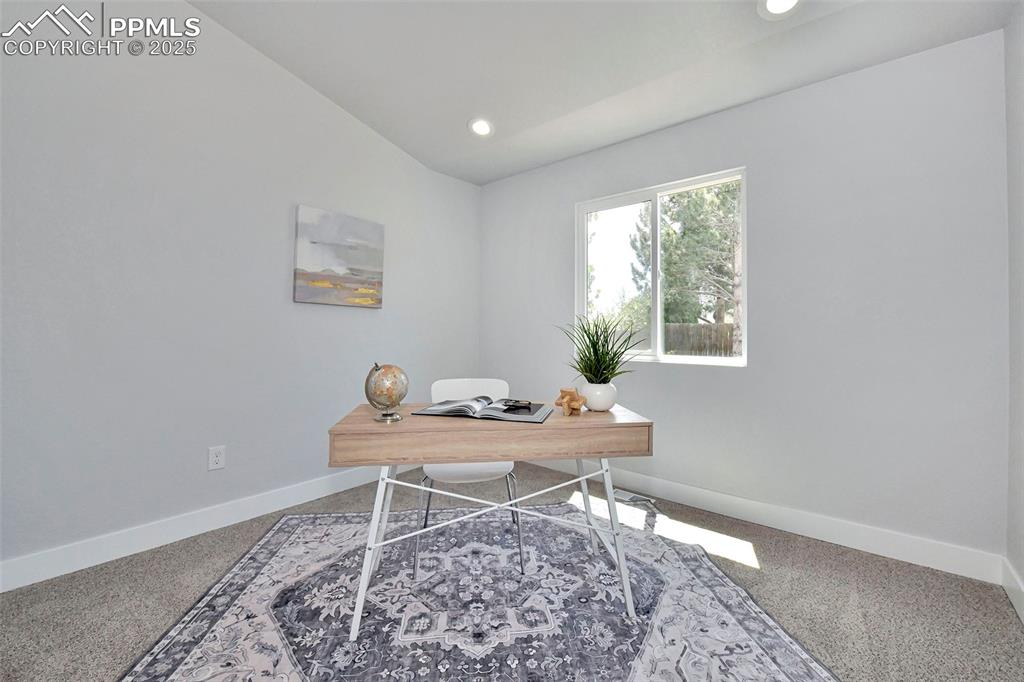 Image 12 of 44: Carpeted office featuring vaulted ceiling and recessed lighting