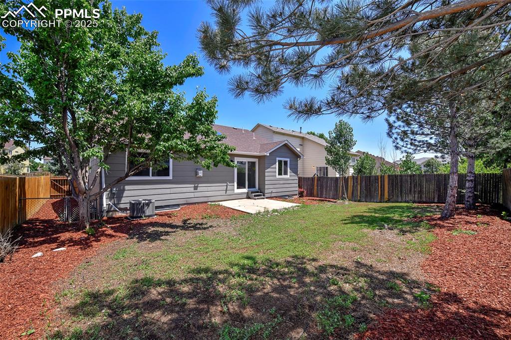 Image 21 of 44: Back of house with a patio and a fenced backyard