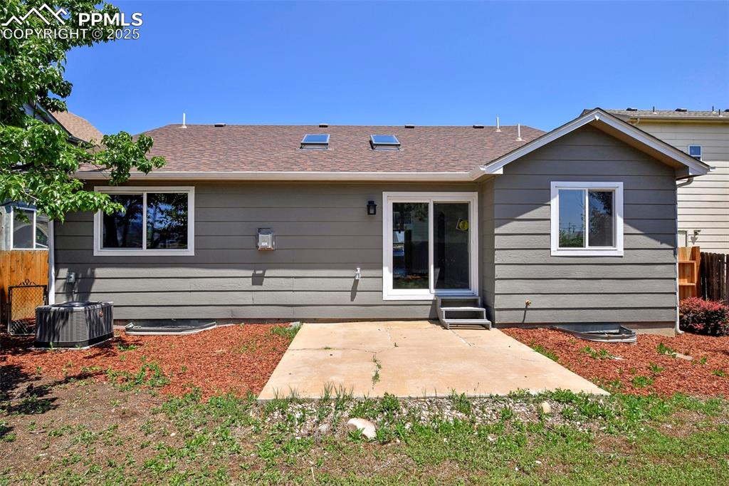 Image 24 of 44: Back of property featuring a patio and roof with shingles