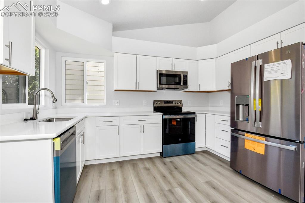Image 26 of 44: Kitchen featuring appliances with stainless steel finishes, light counterto