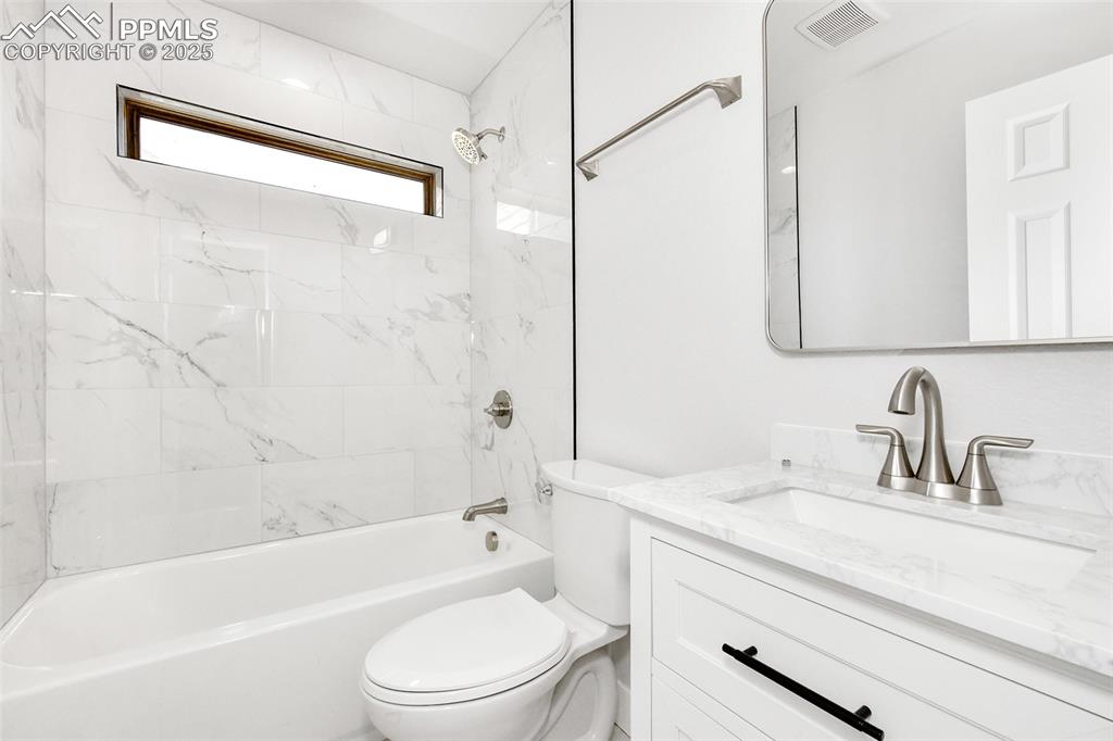 Image 32 of 44: Full bath with vanity and shower / bathtub combination