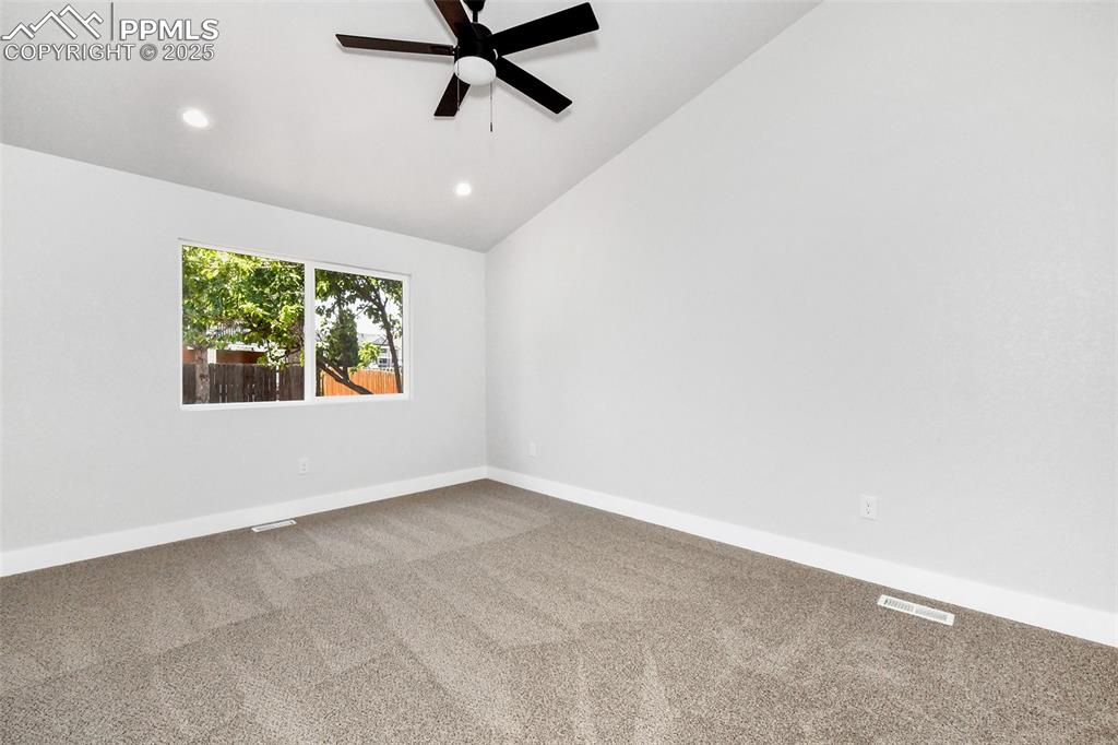 Image 34 of 44: Carpeted spare room featuring ceiling fan, recessed lighting, and high vaul