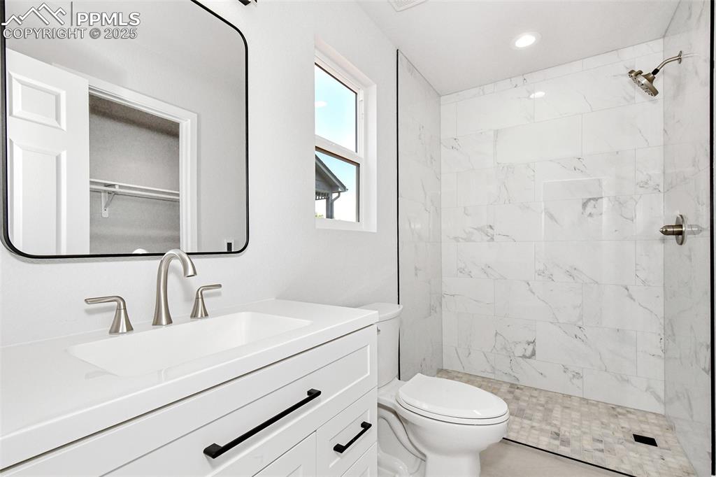 Image 36 of 44: Full bath featuring vanity and tiled shower