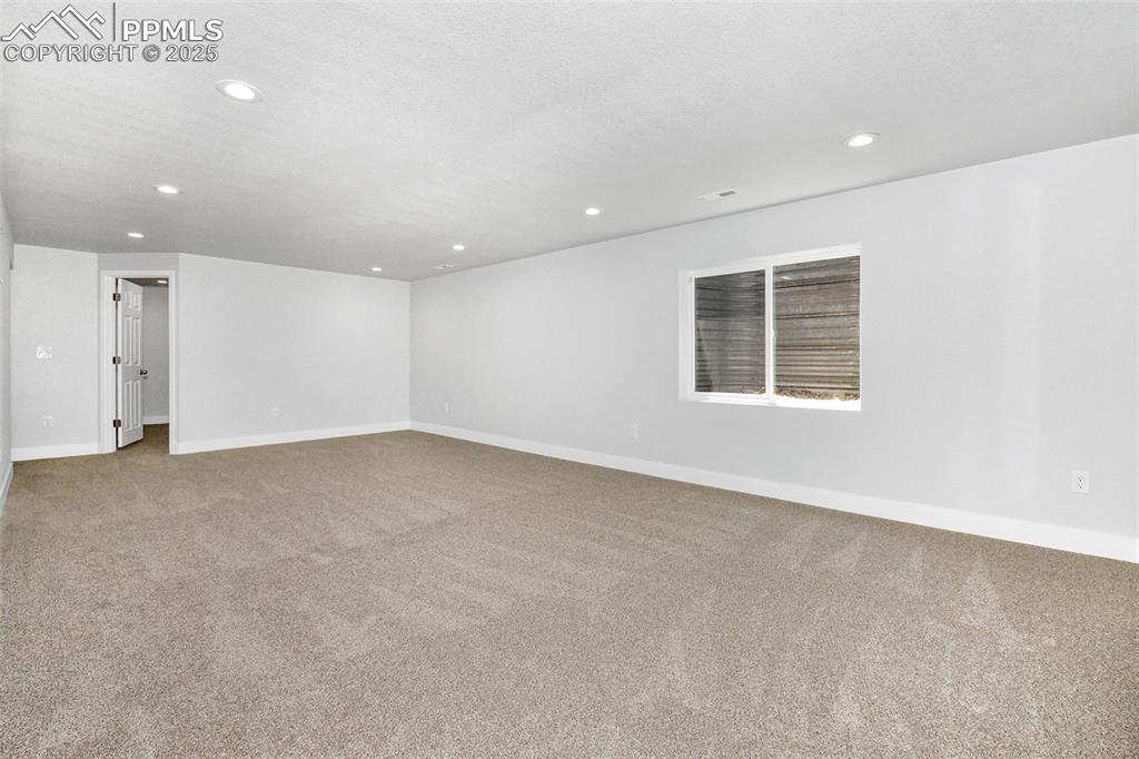 Image 37 of 44: Carpeted empty room with baseboards and recessed lighting