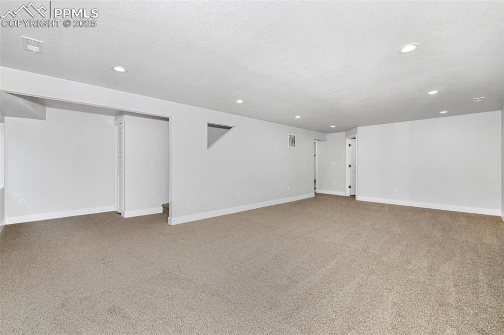 Image 38 of 44: Below grade area with carpet floors, recessed lighting, and a textured ceil