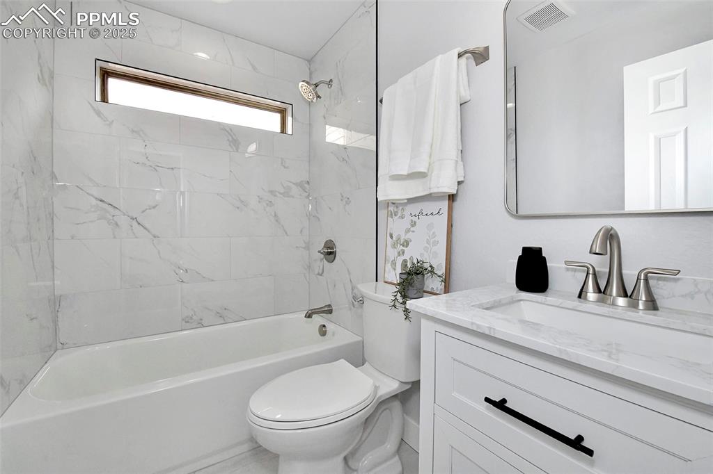Image 4 of 44: Full bath with vanity and shower / washtub combination