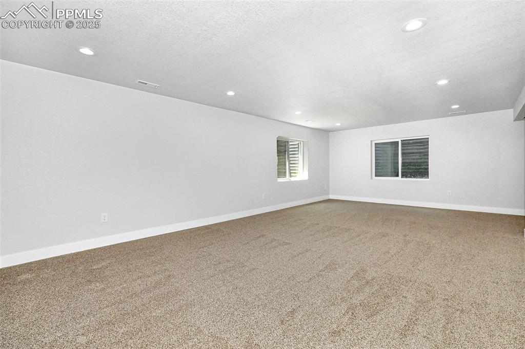 Image 40 of 44: Carpeted empty room with recessed lighting and a textured ceiling