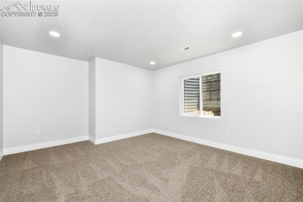 Image 43 of 44: Spare room featuring carpet and recessed lighting