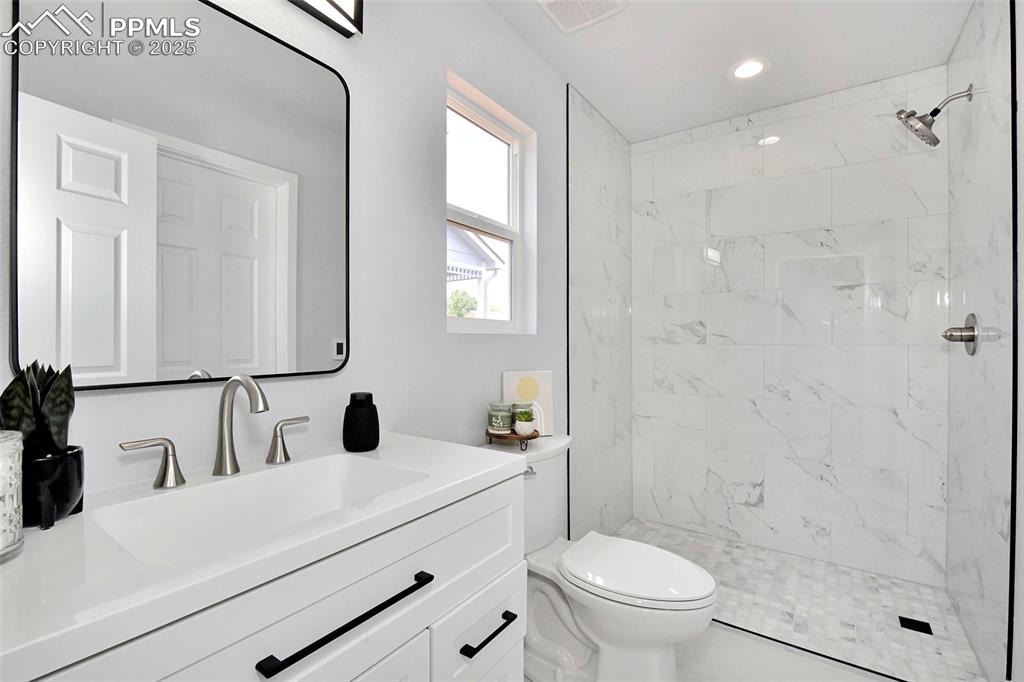 Image 5 of 44: Bathroom featuring vanity and a tile shower