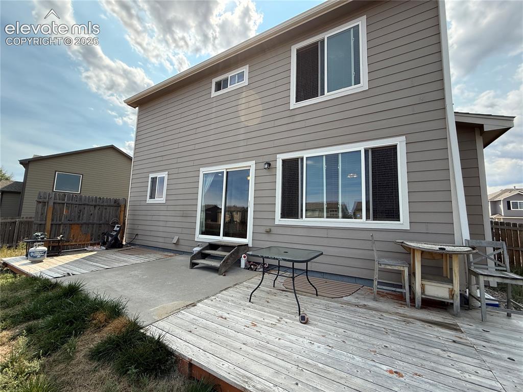 Image 15 of 16: Exterior siding, upper-level windows, ground-level sliding glass door, conc