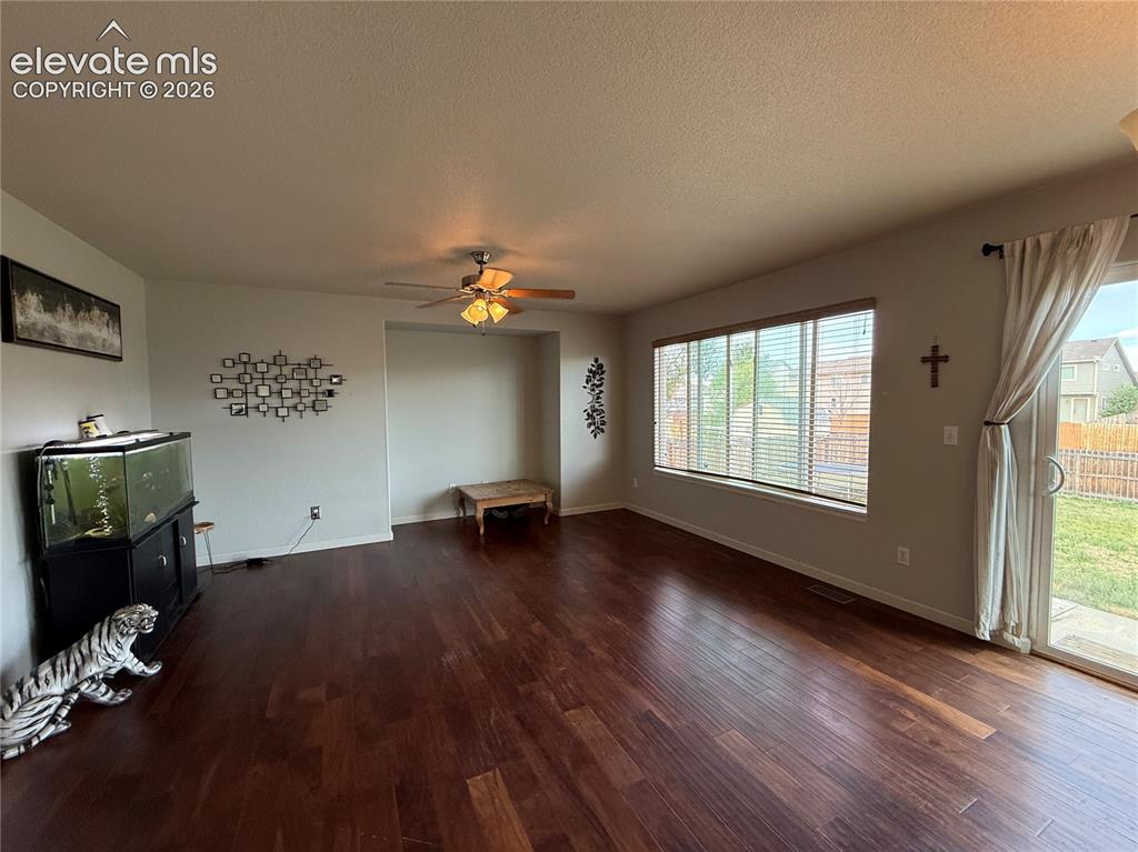 Image 4 of 16: Wood-finish flooring throughout, ceiling fan with integrated lighting, larg