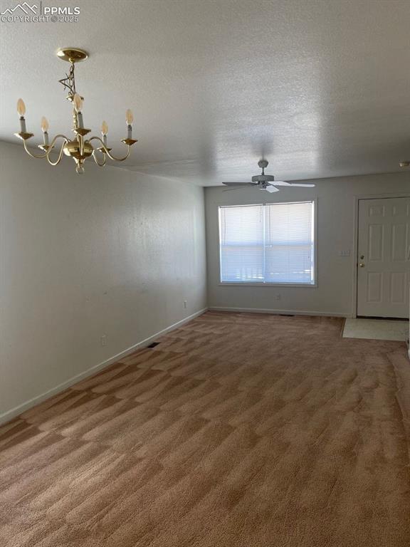 Image 2 of 5: Unfurnished room featuring a textured ceiling, light carpet, a ceiling fan,