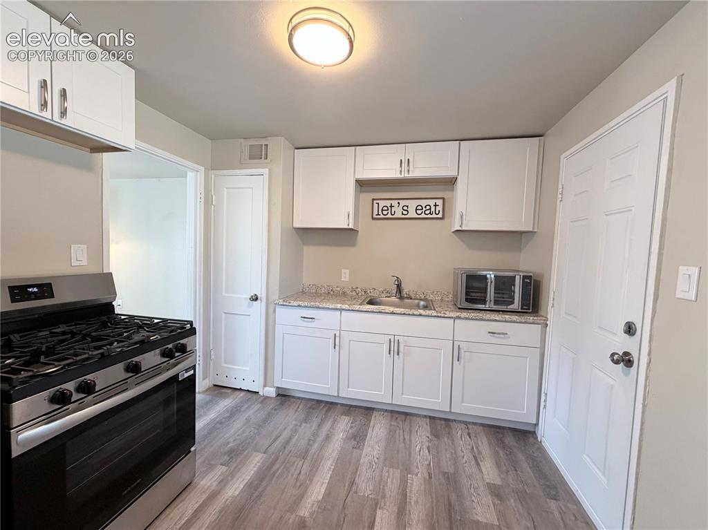 Image 4 of 10: New Fridge and Gas Range