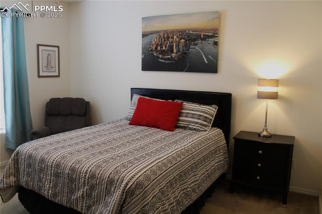 Image 12 of 20: Carpeted bedroom featuring baseboards
