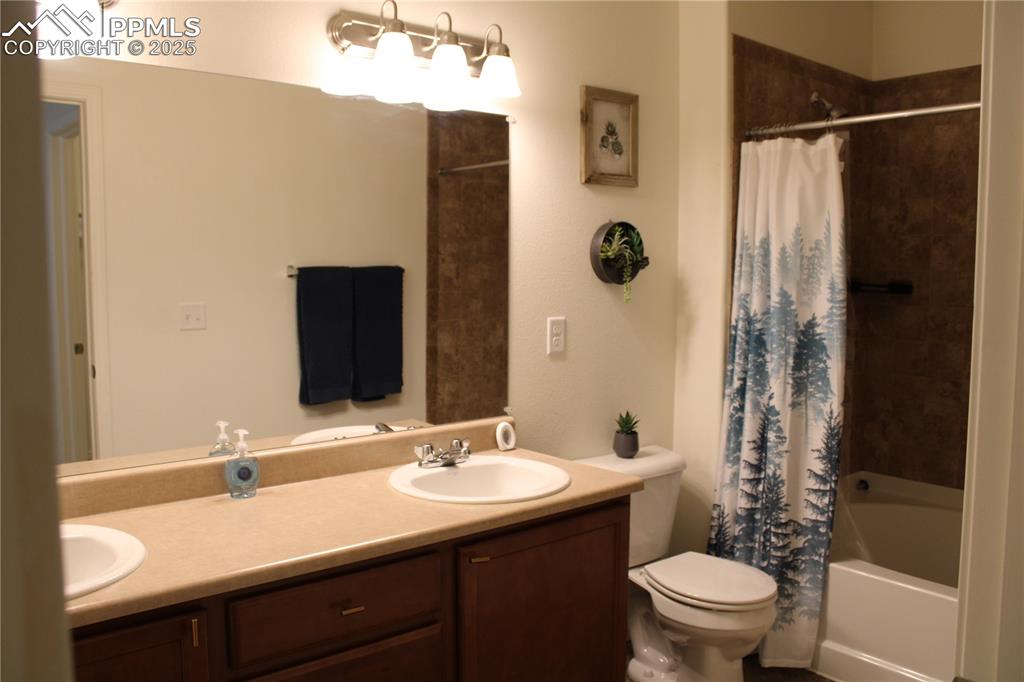 Image 14 of 20: Full bath featuring double vanity and shower / tub combo