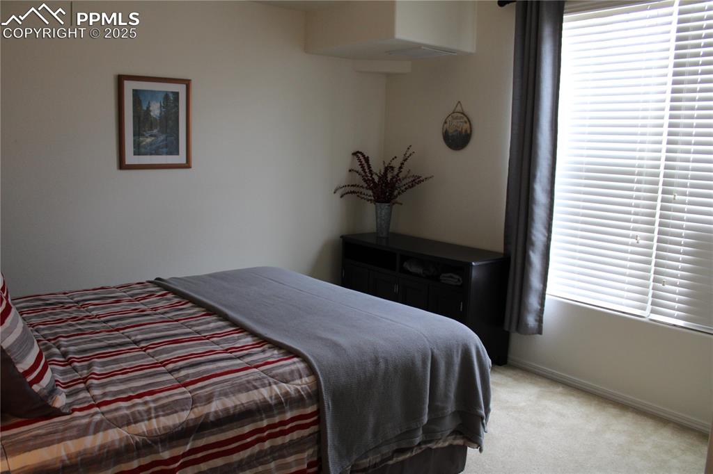 Image 17 of 20: Bedroom featuring light colored carpet and baseboards