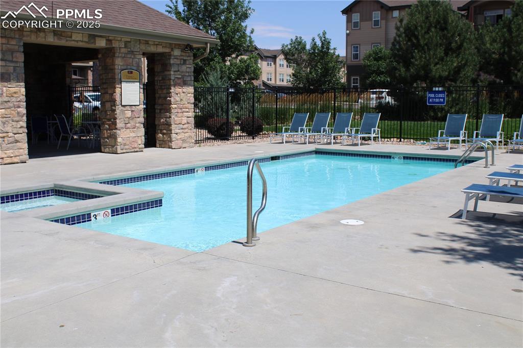 Image 4 of 20: Community pool with a patio and a community hot tub