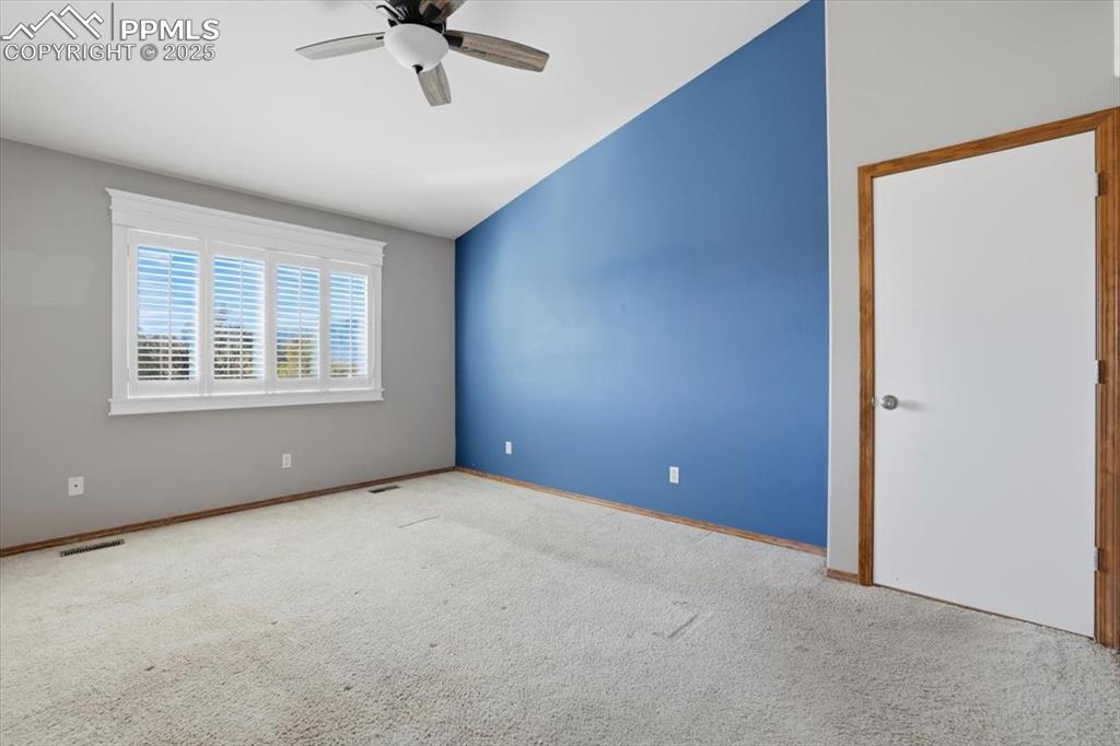 Image 14 of 43: Unfurnished room with vaulted ceiling, carpet, and ceiling fan
