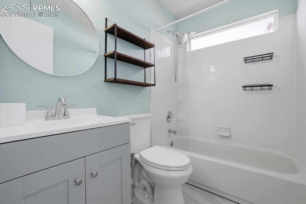 Image 17 of 43: Bathroom with vanity and shower / washtub combination