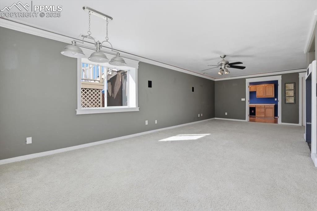 Image 25 of 43: Carpeted empty room with ornamental molding and ceiling fan