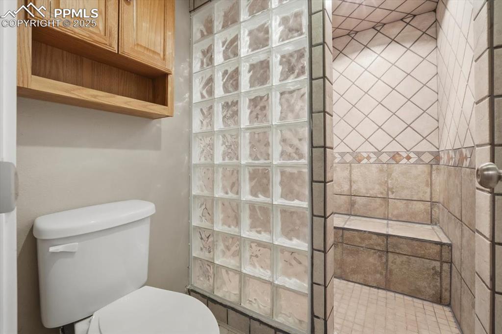 Image 31 of 43: Full bathroom featuring walk in shower and toilet