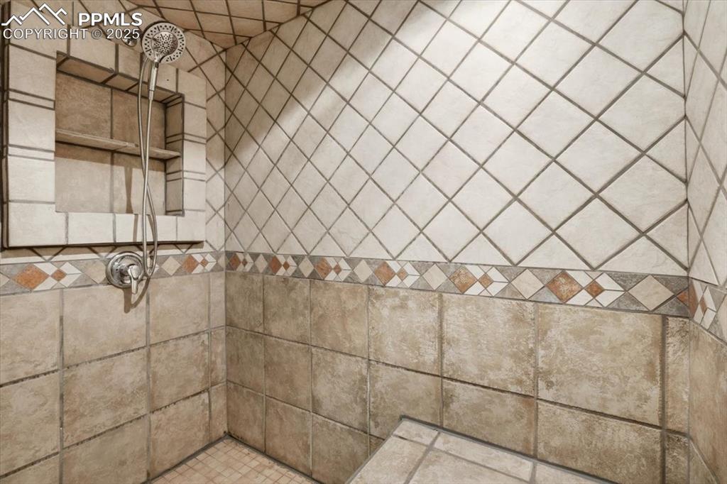 Image 32 of 43: Bathroom view of a tile shower