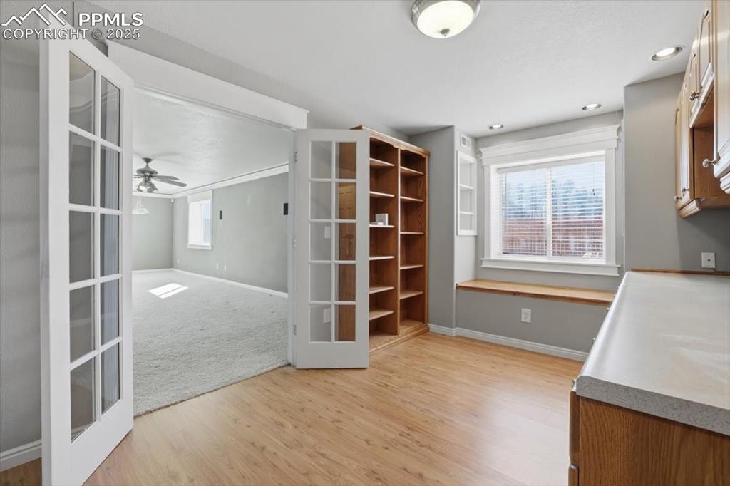 Image 38 of 43: Unfurnished dining area with light wood-type flooring, french doors, and a 