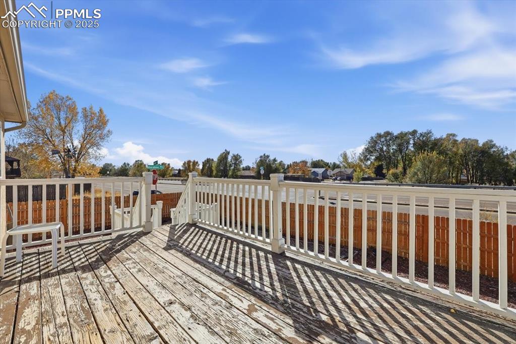 Image 41 of 43: Wooden deck with a fenced backyard