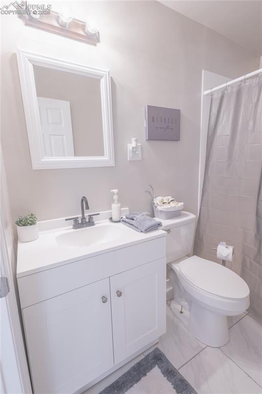 Image 10 of 21: Full bath featuring vanity and a shower with shower curtain