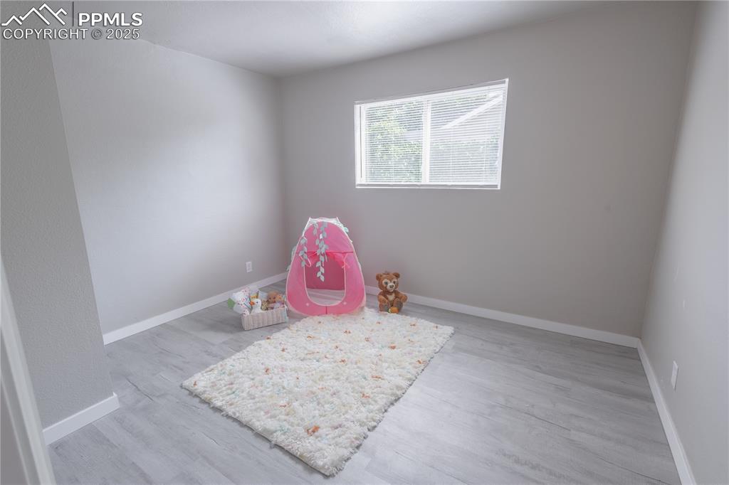 Image 12 of 21: Recreation room with baseboards and light wood finished floors