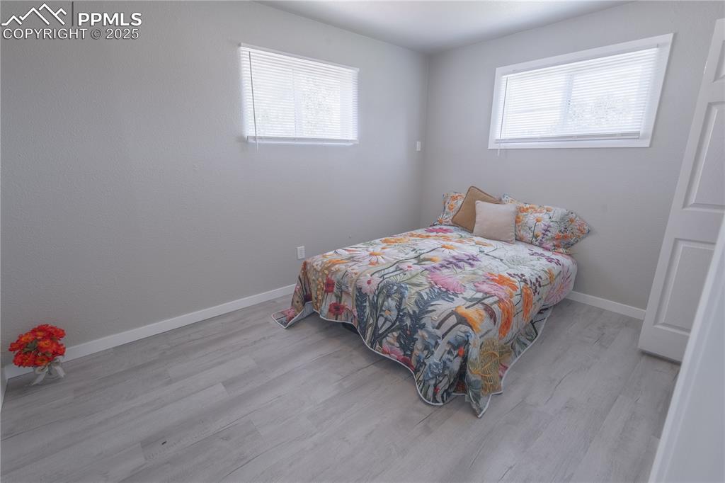 Image 16 of 21: Bedroom featuring light wood-style flooring and multiple windows