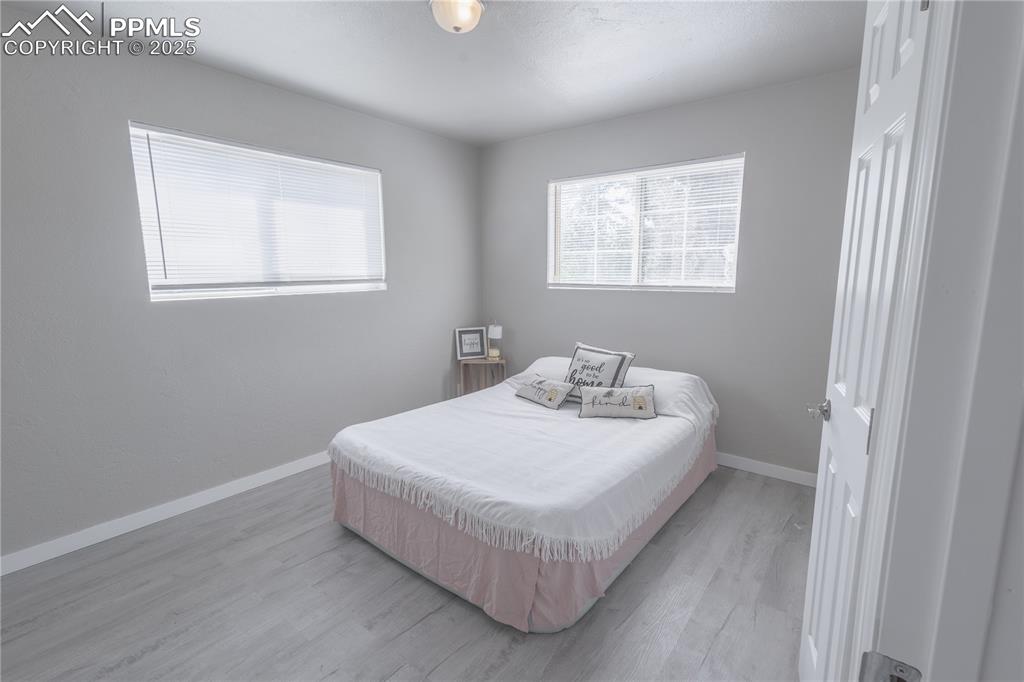 Image 7 of 21: Bedroom with light wood-style floors