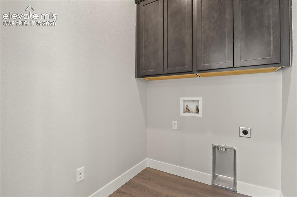 Image 18 of 50: Convenient main level laundry with added storage.