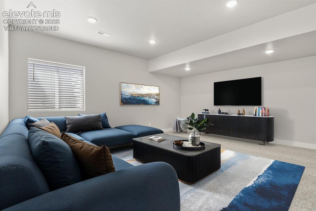 Image 20 of 50: Lower level family room. Virtually Staged