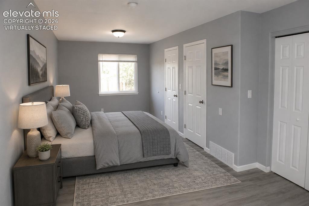 Image 14 of 28: Light gray wall paint, wood-finish flooring, recessed lighting, double-pane