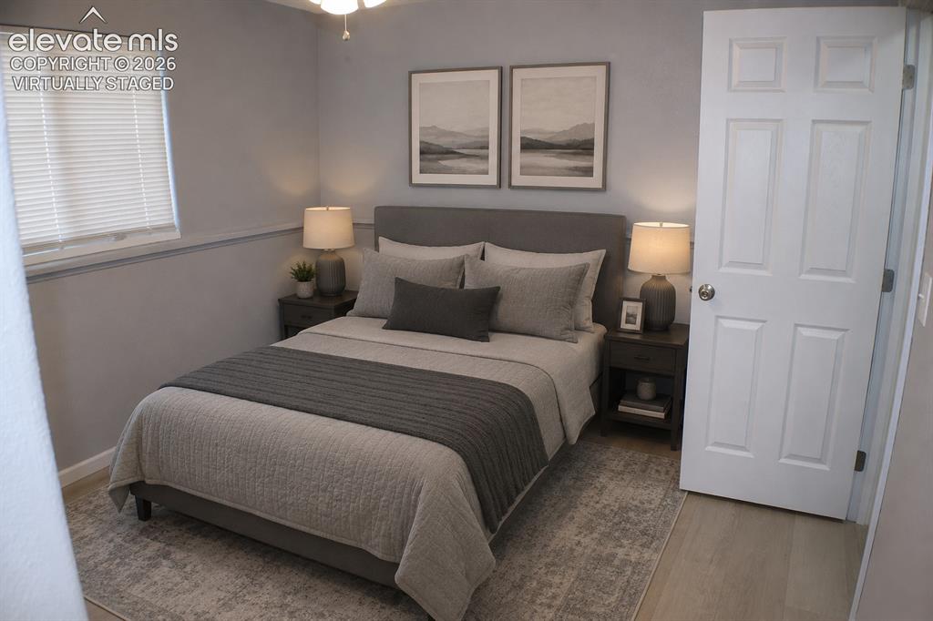 Image 22 of 28: Wood-finish flooring, paneled interior door, and window with blinds virtual