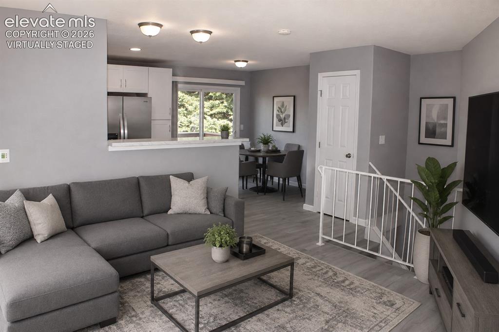 Image 6 of 28: Open-concept living area with gray wall tones and recessed lighting virtual