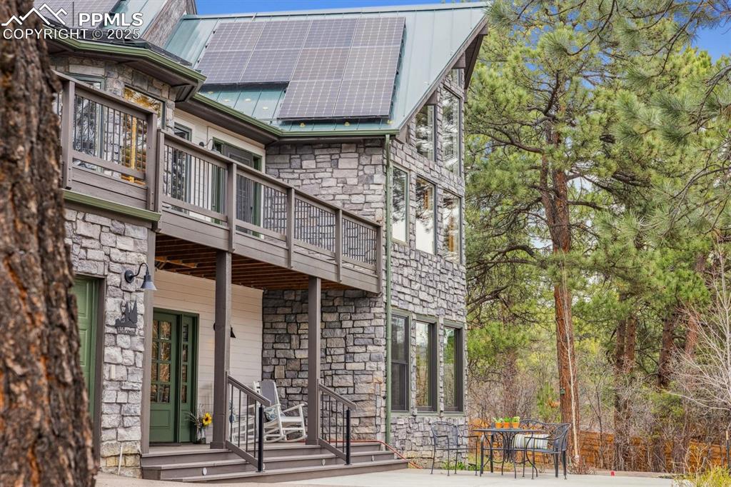 Image 47 of 50: Outdoors, the property boasts several patios, a large deck with a pergola,