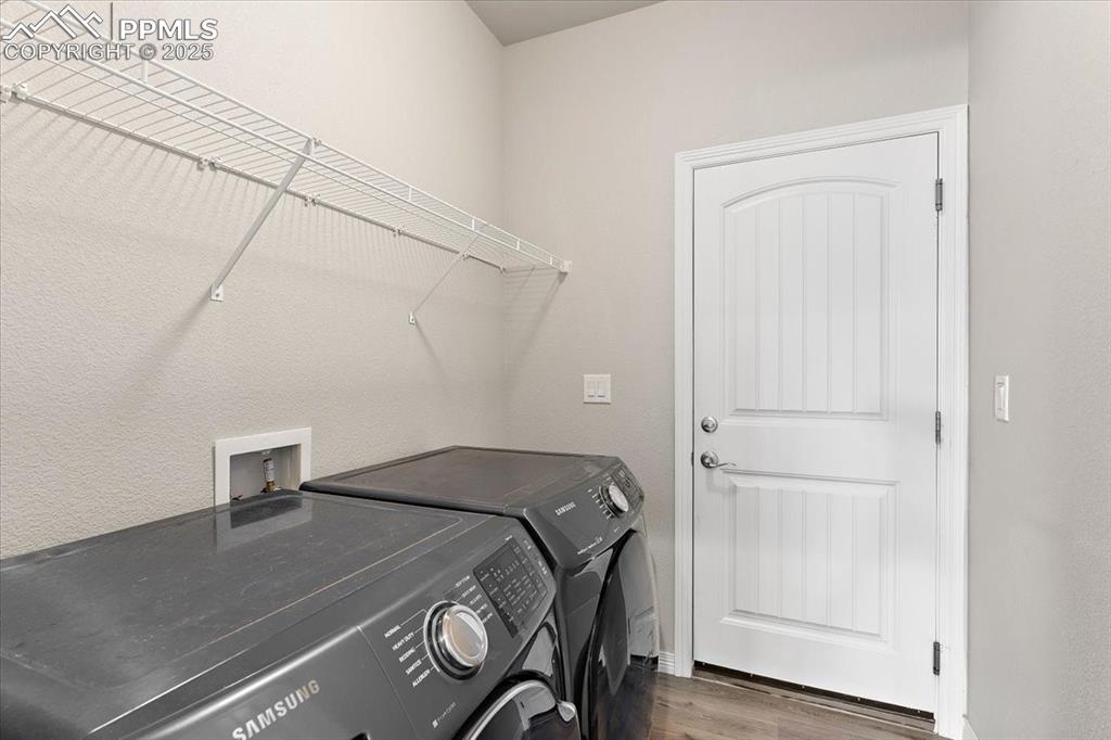 Image 15 of 48: Main level laundry room and inside entrance to the 3-car garage