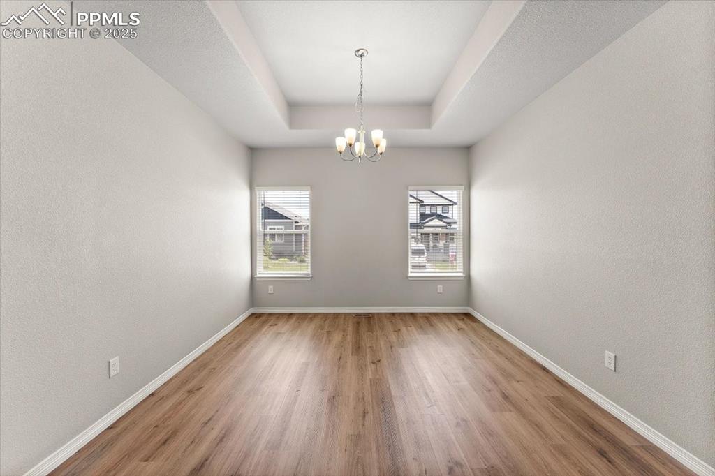 Image 44 of 48: Main level formal dining room, office, flex room