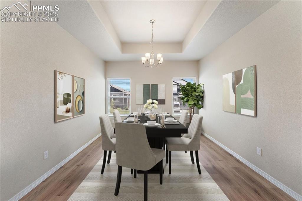 Image 6 of 48: Main level formal dining room, office, flex room - virtually staged