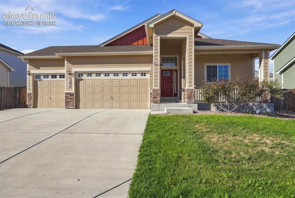 Caption: Contemporary exterior with a covered front porch, dual garage doors, a concrete driveway, and a red 