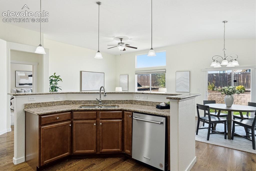 Image 14 of 45: Kitchen island with a stainless steel sink, a stainless steel dishwasher, a