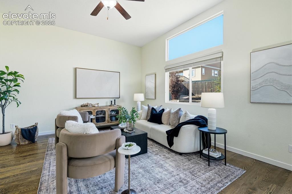 Image 17 of 45: Vaulted ceiling with an attached ceiling fan, large windows with upper tran