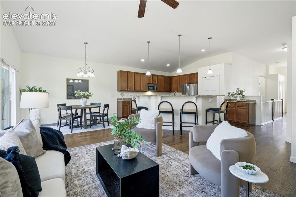 Image 19 of 45: Vaulted ceilings, wood-finish flooring, recessed lighting, built-in kitchen