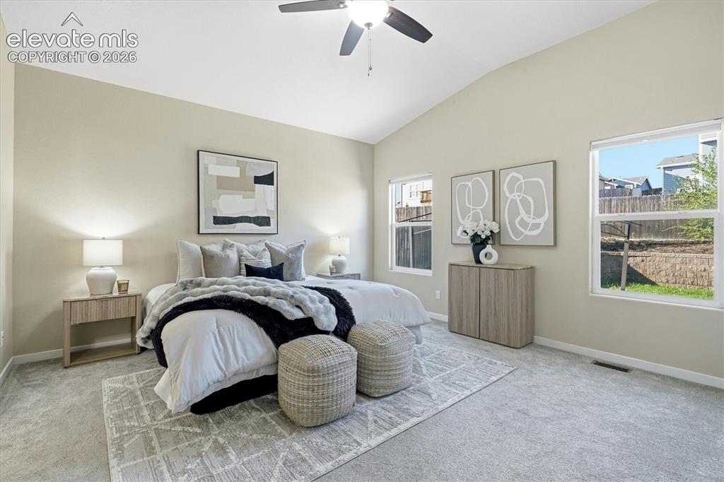 Image 20 of 45: Vaulted ceiling with a ceiling fan, light gray wall paint, light gray carpe