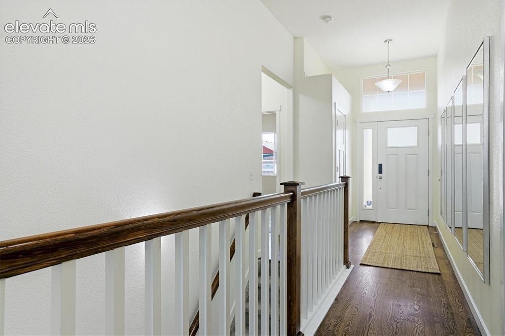 Image 4 of 45: Entryway with dark wood-finish flooring, white paneled door with glass inse