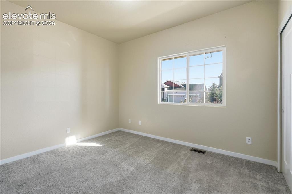 Image 5 of 45: Soft gray carpeting, neutral wall color, white trim, and a white-framed win